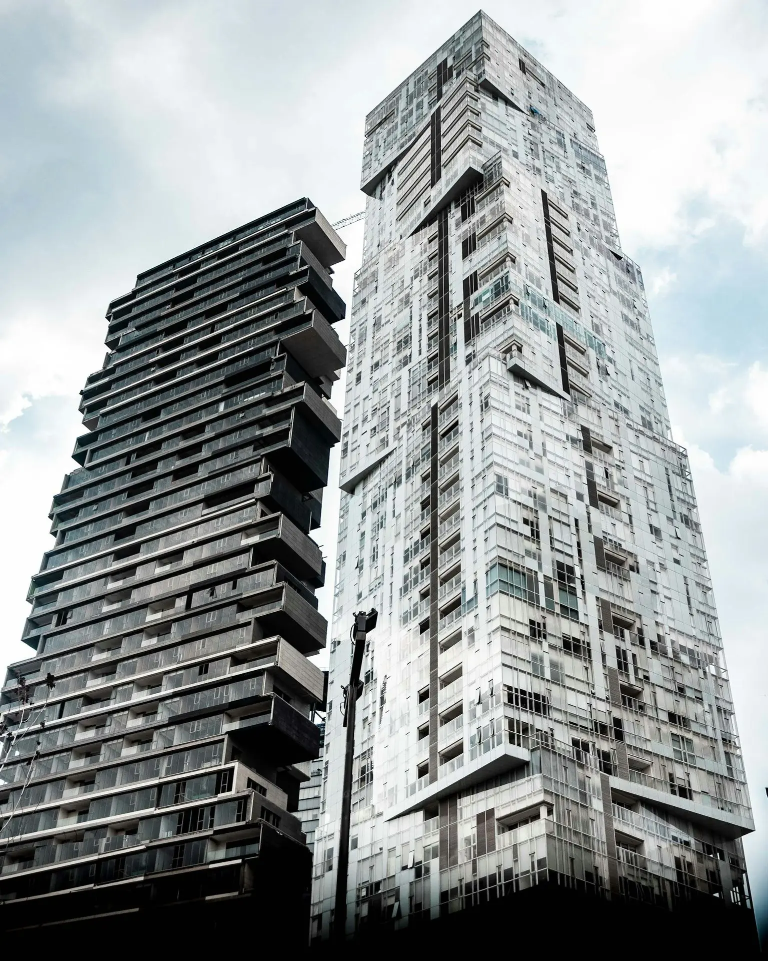 low angle photography of twp black and white high rise buildings